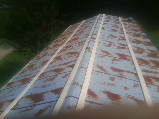 Rusted metal roof panels with new wood purlins before replacement — Storm Damage Roof Repair in Wasco by Roofing Brothers